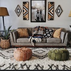 a living room filled with lots of furniture and pictures on the wall above it's couch