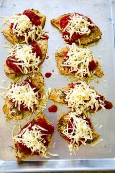 several pieces of pizza with sauce and cheese on them sitting in a baking pan, ready to be baked