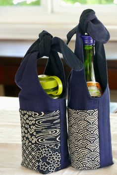 two bags with bottles in them sitting on a table