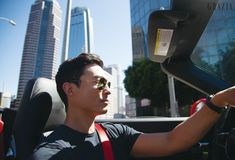 a man sitting in the driver's seat of a car