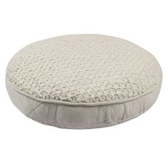 a white round dog bed on a white background