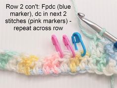 the crochet stitch is being worked on with scissors and yarn in front of it