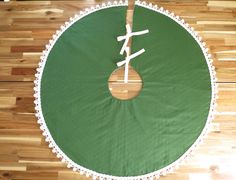 a green table with white doily on it and a wooden spoon in the center