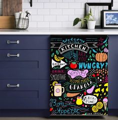 a kitchen with blue cabinets and white countertops has a chalkboard design on it