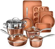 copper colored pots and pans with matching utensils are shown in this image