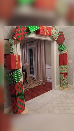 two christmas presents are stacked on top of each other in front of a mirror with the door open