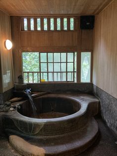 a large stone bath tub in a wooden room