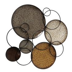 an abstract metal sculpture with five circles on it