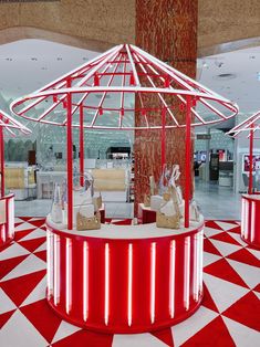 a red and white checkered floor with umbrellas