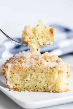 a piece of cake on a white plate with a fork in it and a bite taken out