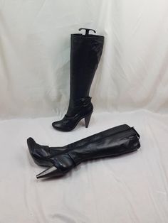 I bring to your attention black high leather boots to the knee. Soft genuine leather. Vintage square toe zip boots are very rare. These beautiful boots with a skirt or dress look very nice. Buckle leather boots with a strap on the side, unique. Made in Brazil. These fashionable boots look great, inside whole, in excellent condition. In a single copy. Women's boots with high heels under the tree, very elegant. Vintage 90s. Materials: leather The shaft circumference - 14 Inches Boots height - 19 I Fitted Leather Moto Boots With High Heel, Fitted Leather High Ankle Knee-high Boots, Fitted Platform Boots With Buckle Closure, Fitted Knee-high Leather Moto Boots, Fitted Knee-high Heeled Boots With Buckle, Knee-high Leather Moto Boots, Fitted Knee-high Boots With Buckle Closure And Round Toe, Fitted Knee-high Heeled Boots With Buckle Closure, Vintage Black Fitted Knee-high Boots