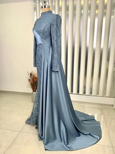 It is a lined, lace front draped dress.  It is made of 100% lace and satin fabric.  It is a lapel dress.  It is 152 cm long. Long Sleeve Dresses For Mother Of The Bride, Long Sleeve Gown With Sweep Train, Blue Long Dress For Wedding, Elegant Fitted Blue Abaya, Formal Fitted Long Abaya, Blue Long Sleeve Mother Of The Bride Dress, Long Sleeve Evening Dress For Eid, Long Sleeve Evening Dress For Eid Wedding, Elegant Long Sleeve Evening Dress For Eid