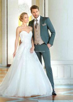 a man and woman in wedding attire posing for the camera