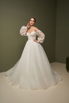 a woman in a wedding dress posing for the camera with her hands on her head