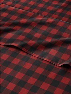 a red and black checkered fabric is shown in close up view on the bottom