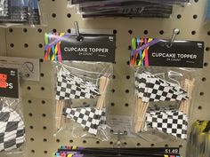 some cupcake toppers are in plastic bags on the store shelf with price tags