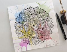 a watercolor and ink drawing of a flower on white paper with paint splatters