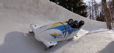 a snowboarder is going down a hill with his skis strapped to the side