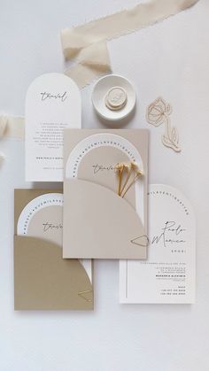 the wedding stationery is laid out on top of each other