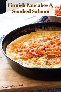 an omelet is sitting in a pan on a table next to another dish