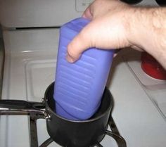 a person is pouring something into a pot on the stove