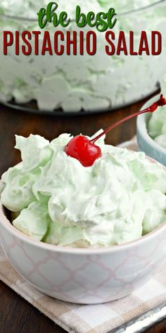 the best pistachio salad is in a white bowl with a cherry on top