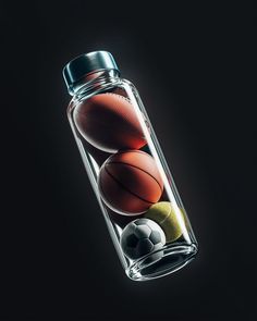 a glass bottle filled with basketballs and balls