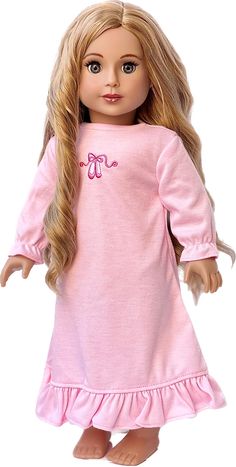 a doll with blonde hair wearing a pink nightgown and holding her hand out to the side