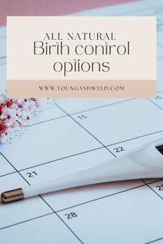 a white toothbrush sitting on top of a calendar next to pink flowers and a pen