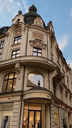 an ornate building with many windows and people walking by