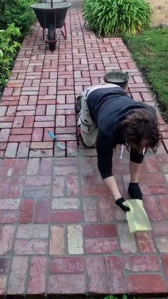 a woman bending over to pick up something off the ground