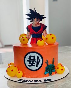 a birthday cake decorated with an image of gohan and dragon ball decorations on top