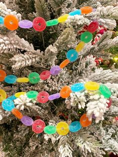 a christmas tree decorated with candy and frosted donuts on it's branches