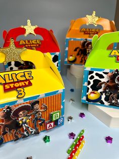 three boxes with toy characters on them and confetti in the middle one has a star