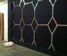 a black wall with silver lines on it