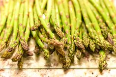 asparagus spears with brown spots on them sitting on a counter top, ready to be cooked