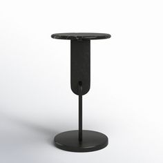 a black table with a round top and metal base on an isolated white background,