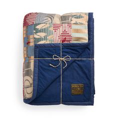 a blue quilted blanket wrapped in twine