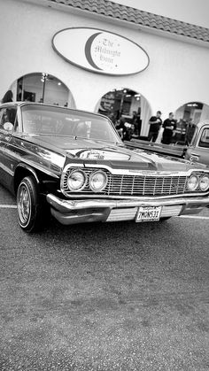 an old car parked in front of a building