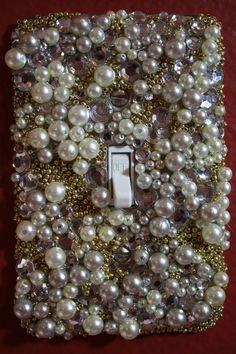 a light switch cover with pearls on it