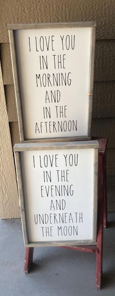 two wooden signs sitting on top of a cement floor next to each other with writing on them