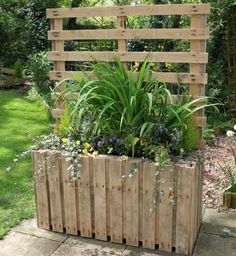 a wooden planter filled with lots of plants