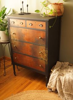 an old dresser with some plants on top of it