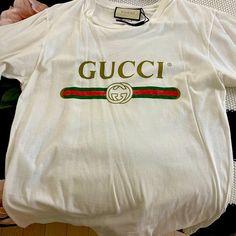 Authentic Never Worn Trendy Gucci Crew Neck T-shirt, Trendy Gucci Cotton T-shirt, Gucci White T-shirt With Letter Print, Trendy Gucci Tops With Letter Print, Trendy White Gucci Tops, Trendy Gucci Short Sleeve T-shirt, Designer Gucci Tops With Logo Print, Designer Gucci Tops With Letter Print, Gucci Designer T-shirt With Letter Print