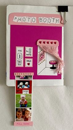 a pink photo booth with pictures and magnets attached to the back of it's frame