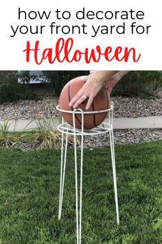 a basketball sitting on top of a metal stand in the grass with text overlay saying how to decorate your front yard for halloween