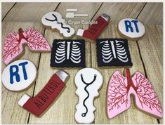 decorated cookies with medical related items on wooden table next to scissors and stethoscope