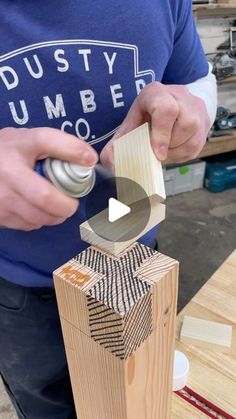 a man is working on some wood with a screwdriver and an object in his hand