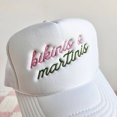 Bikinis & Martinis Embroidered Trucker Hat 100% polyester Foam trucker hat with mesh back, adjustable snap closure and embroidered design. Bach Trucker Hats, Fun White Trucker Hat For Beach Season, Summer White Trucker Hat With Embroidered Logo, White Embroidered Logo Trucker Hat For Summer, Adjustable White Summer Trucker Hat, White Embroidered Trucker Hat For Summer, White Playful Hat With Adjustable Fit, Playful White Hat With Adjustable Fit, Summer Adjustable Trucker Hat With Embroidered Logo