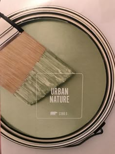 a paint can with a brush in it and the words urban nature painted on it